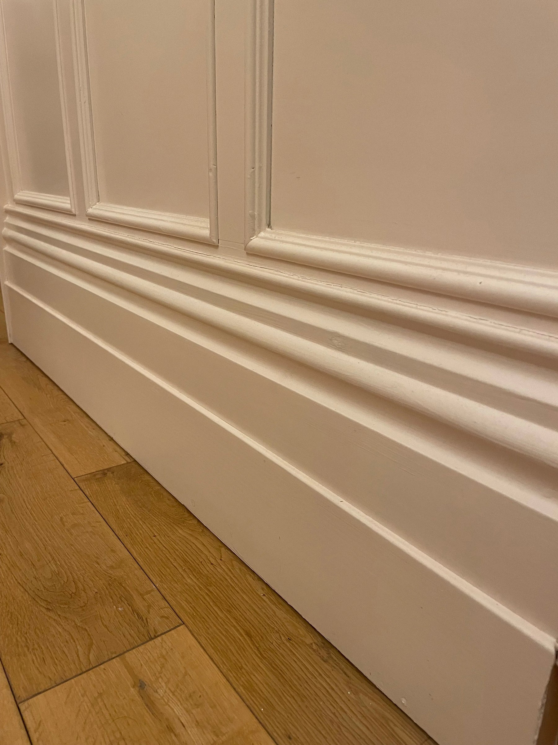 10 inch skirting board with painted shaker style panelling above with inset timber mouldings